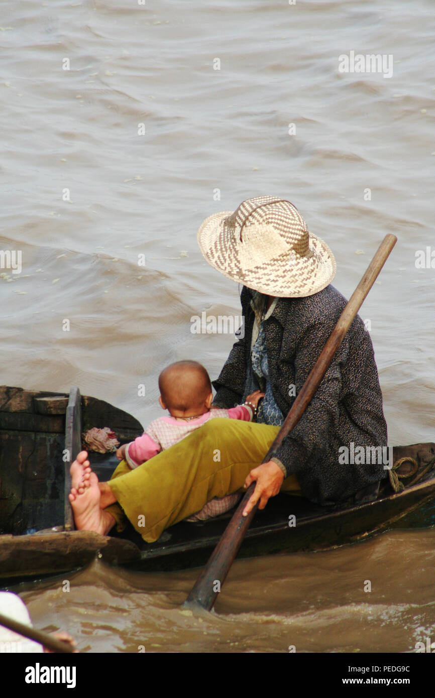 Mother and child on Boat, Tonle Sap Lake, Siem Reap, Cambodia Stock Photo