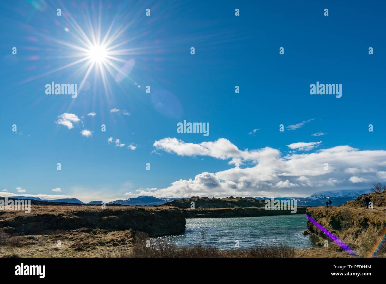 Sunny day, blue sky, sun ray, water, waters edge, low clouds Stock Photo