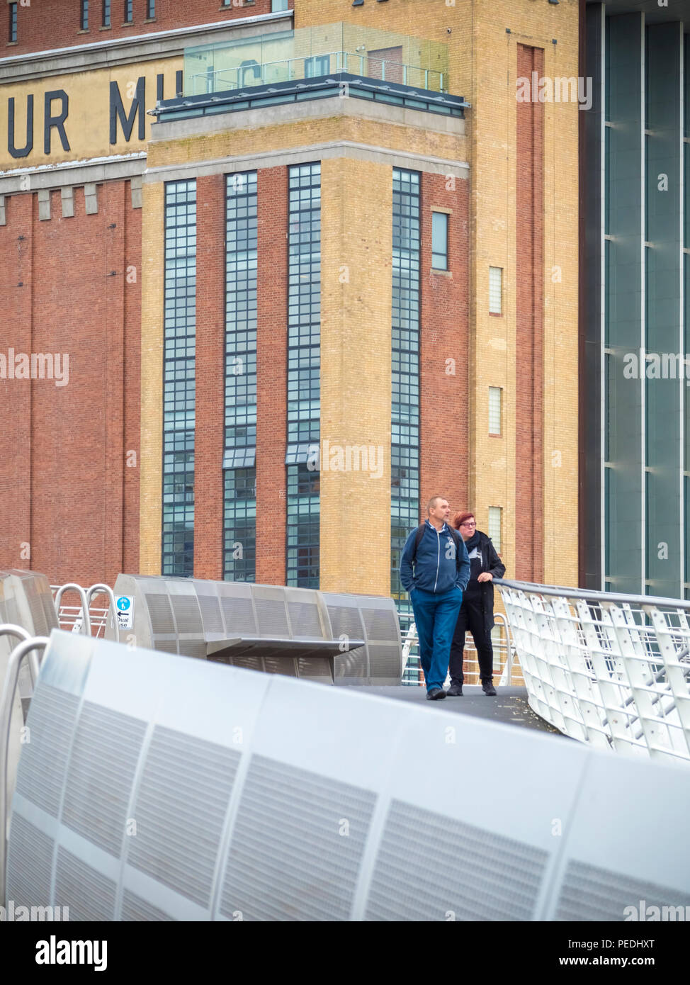 People on the Millennium bridge over the River Tyne with The Baltic in the background Stock Photo