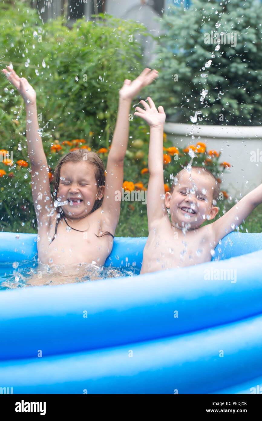 Children bathe in an inflatable blue swimming pool Stock Photo Alamy