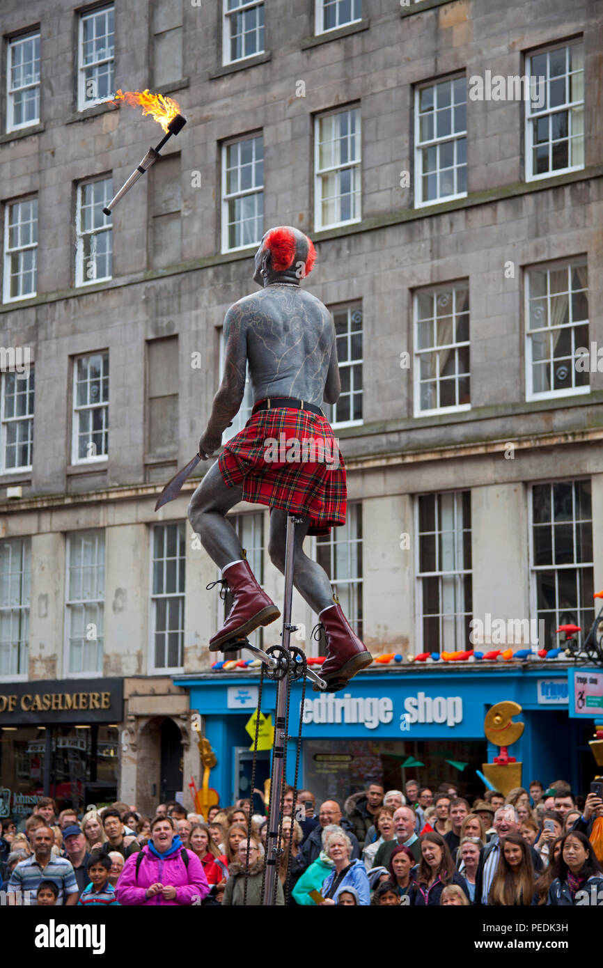 Edinburgh Fringe Festival 2018, performer with tattoos juggles fire torch Edinburgh, Scotland, UK Stock Photo