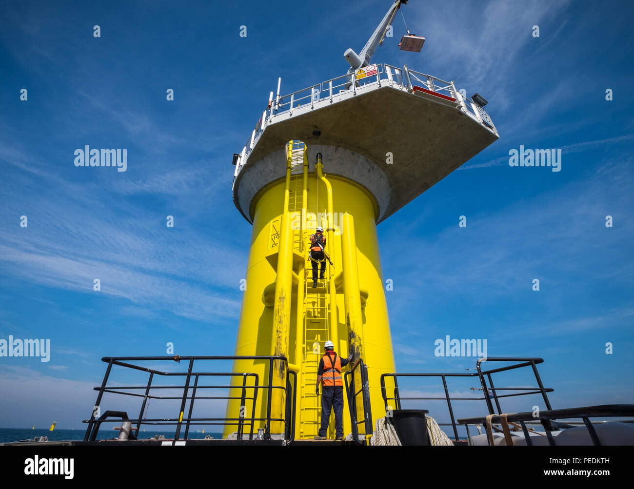 A worker transferring from a Transition Piece on the Race Bank Offshore Wind Farm in the Southern North Sea, UK Stock Photo