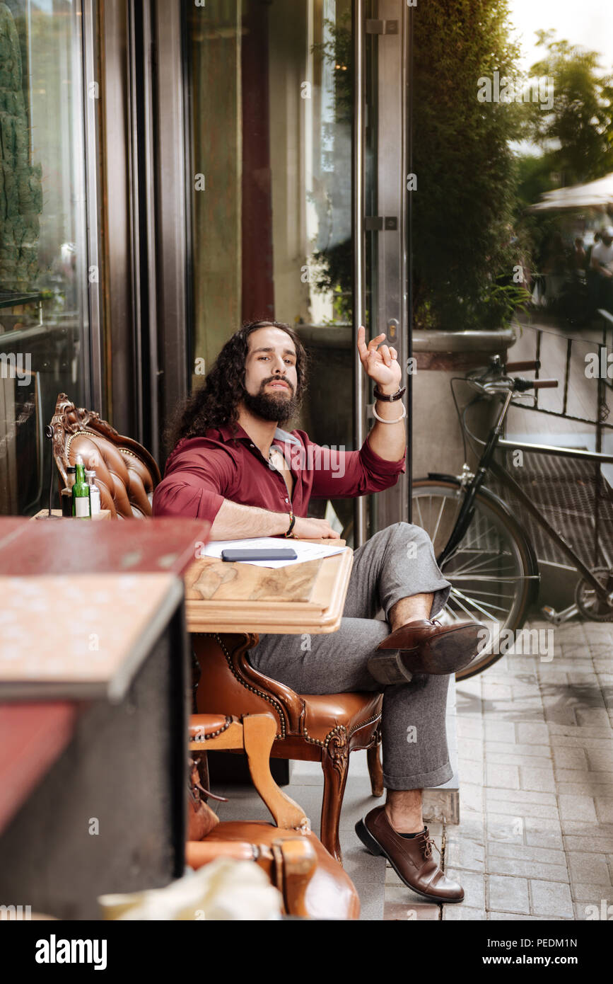 Nice bearded man sitting in the cafeteria Stock Photo