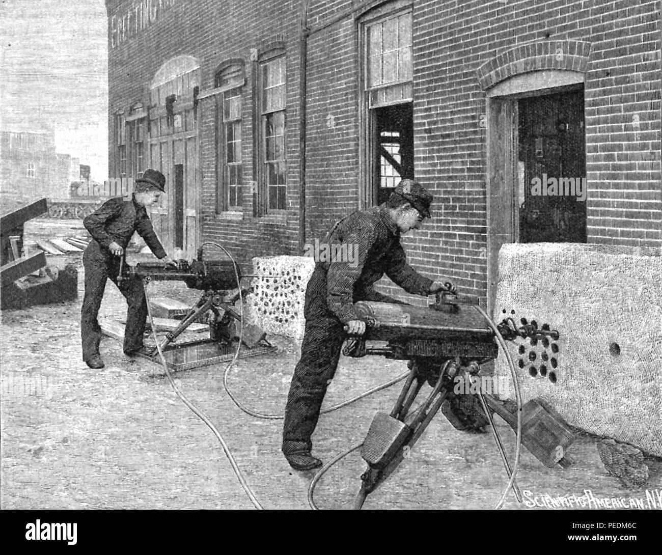 Black and white engraving showing two men using a pair of Edison Electric Rock Drills to drill into stone slabs mounted at the base of a large brick building, from Volume 65, Number 20 of the journal 'Scientific American', 1891. Courtesy Internet Archive. () Stock Photo