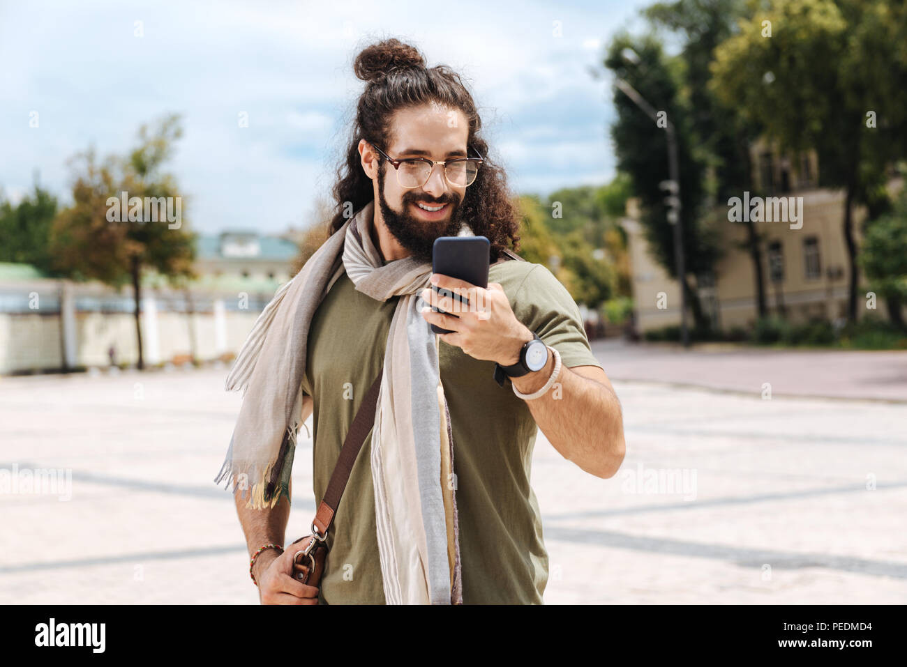 Happy nice man looking at the smartphone screen Stock Photo