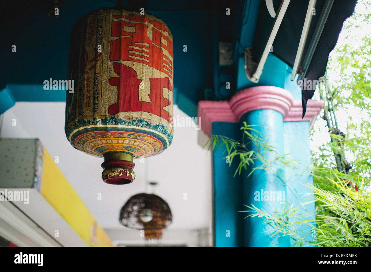 Traditional, old-fashioned Peranakan lantern hanging in a covered walkway in the Joo Chiat / Katong area of Eastern Singapore Stock Photo