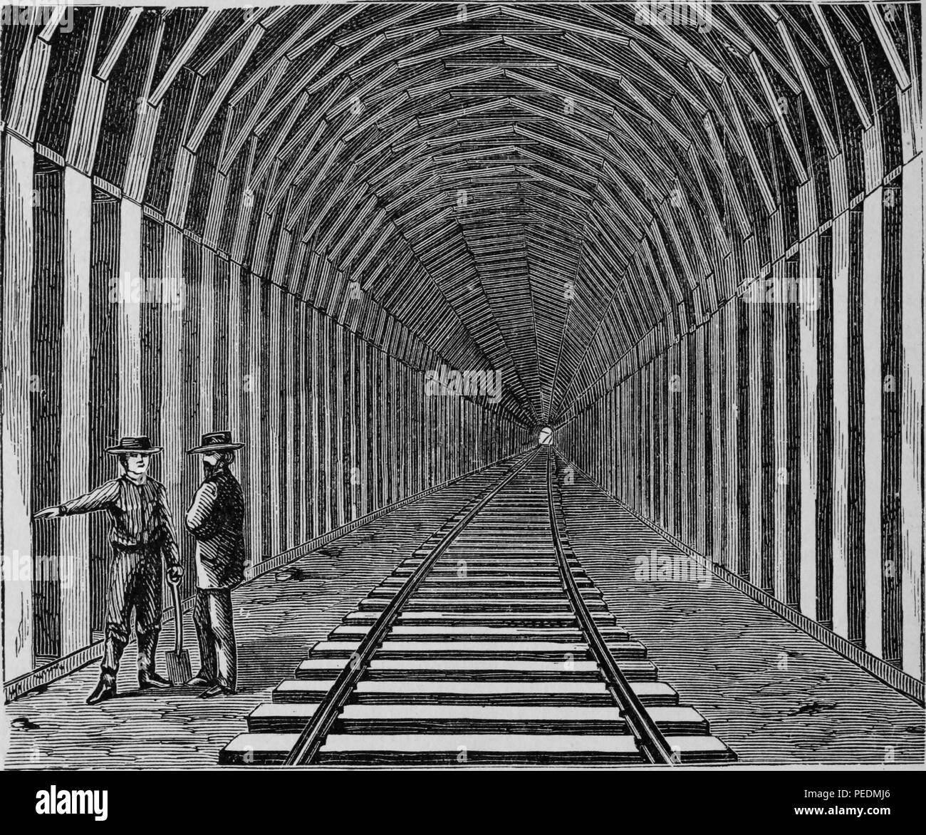 Black and white print illustrating a late nineteenth-century view of the interior of the Livermore Pass Rail Tunnel, located in Alameda County, California, with two men, one holding a shovel, in the left foreground, 1879. Courtesy Internet Archive. () Stock Photo