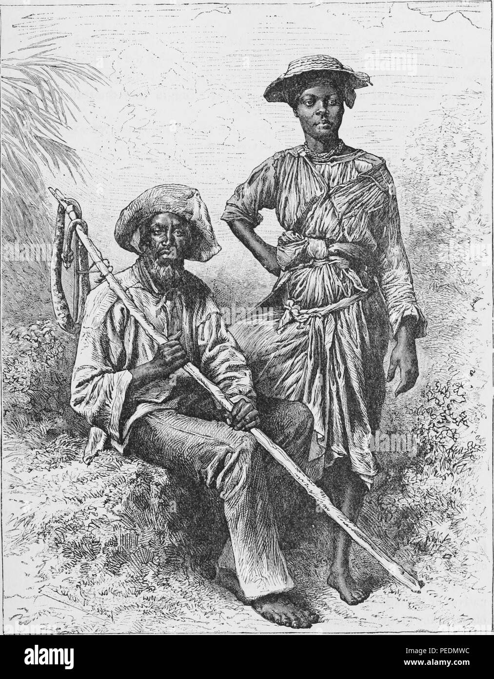Black and white print depicting a 'Snake-Catcher and Charcoal Girl' in Martinique, West Indies, the seated man wears a hat and slings a long stick over his shoulder, the woman stands next to him, wearing a small brimmed hat and an intricately wrapped and knotted dress, both face the viewer with serious expressions on their faces, 1891. Courtesy Internet Archive. () Stock Photo