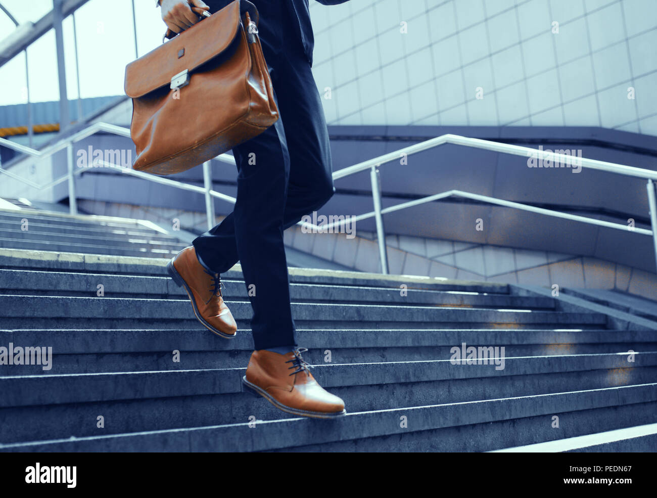 Businessman walking down stairs hi-res stock photography and images - Alamy