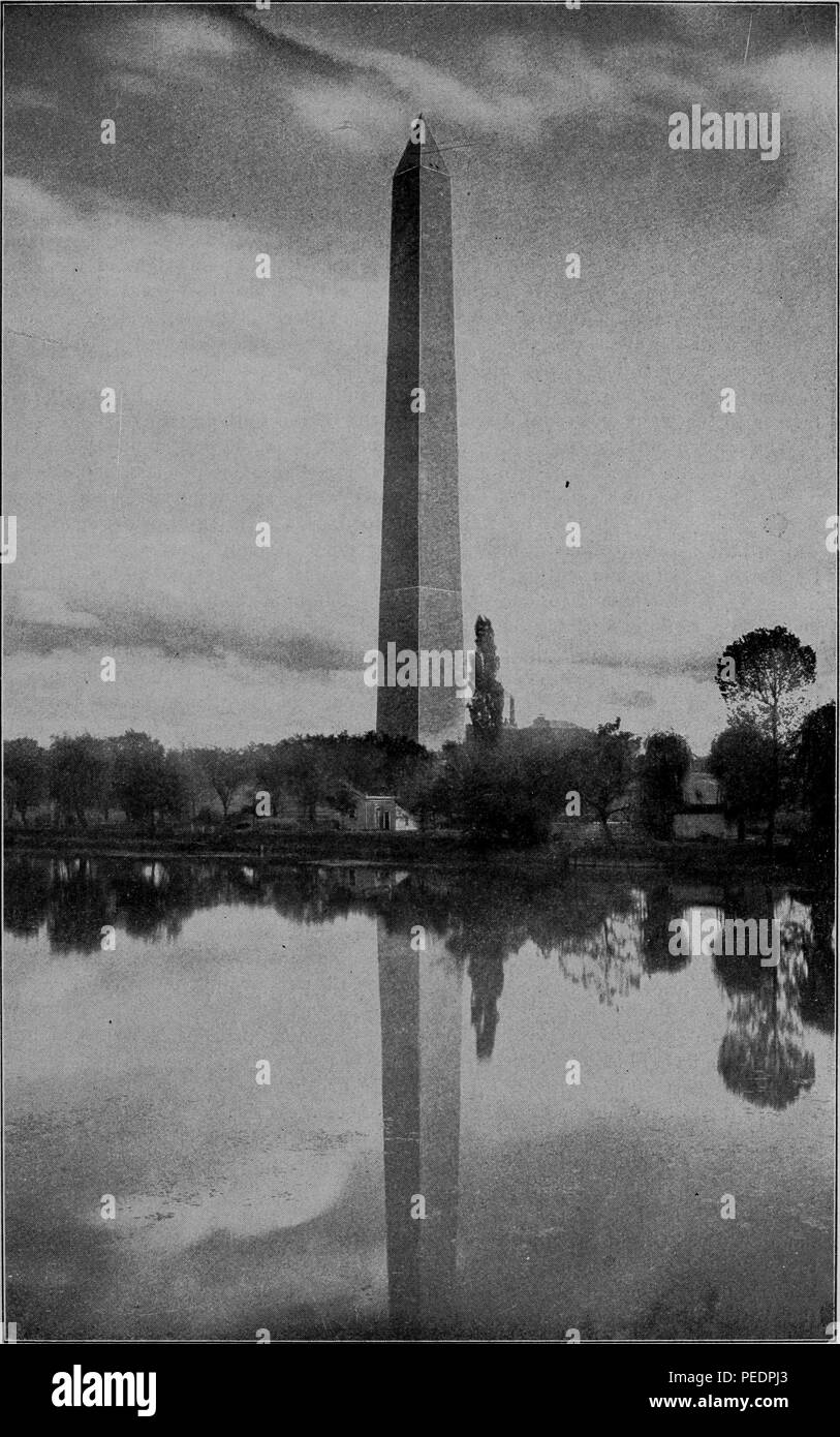 Black and white photograph of the Washington Monument, partially reflected in the Lincoln Memorial Reflecting Pool, from 'Rand, McNally and Co's pictorial guide to Washington and Environs', 1903. Courtesy Internet Archive. () Stock Photo