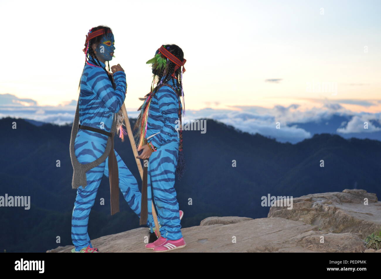2 young avatar girls Keytiri & Feytiri arriving at mt. Ulap  just before the dawn is breaking and awaiting the morning sun at the Corral Rock Ampucao. Stock Photo
