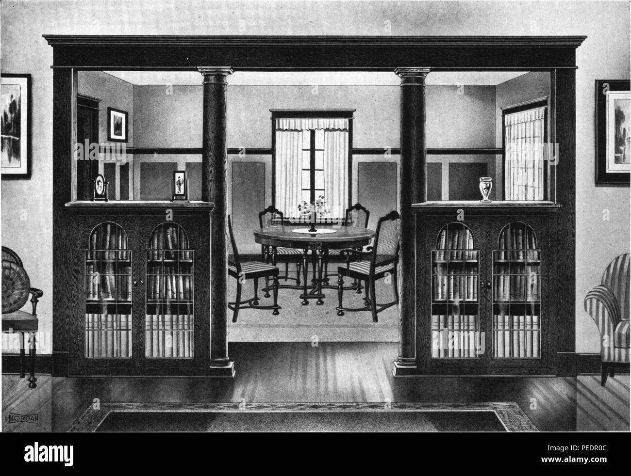 Black and white print depicting a domestic interior, with a wooden colonnade separating a dining area from another room, intended to advertise woodworking design 'Colonnade M-309, ' described as creating a 'Colonial effect, with the advantages of two generous sized bookcases, ' issued by the Morgan Woodworking Organization, 1921. Courtesy Internet Archive. () Stock Photo