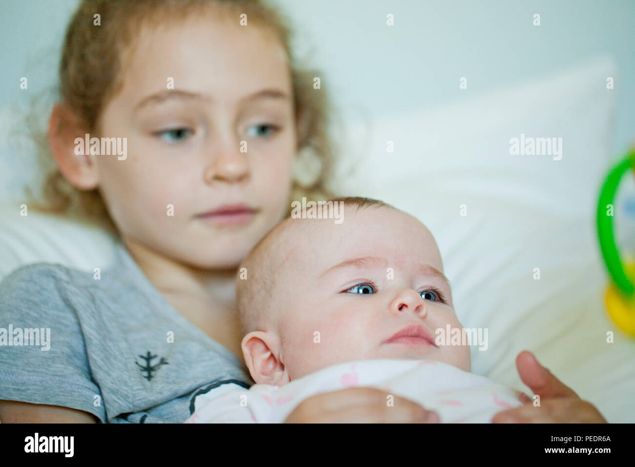 Girl holding baby girl Stock Photo Alamy