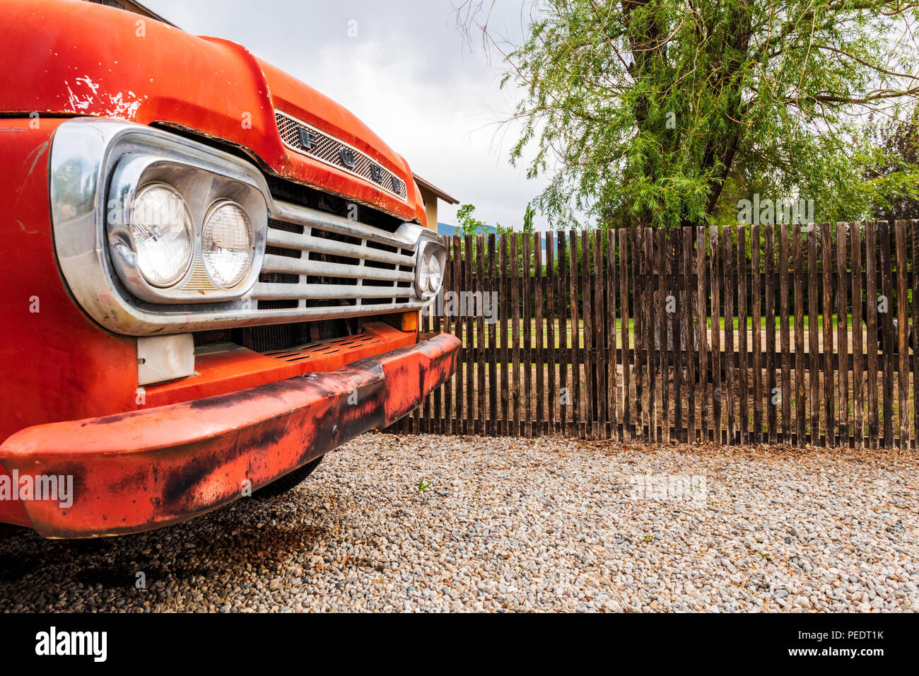 Antique Ford pick-up truck; wooden slat picket fence; Salida; Colorado; USA Stock Photo