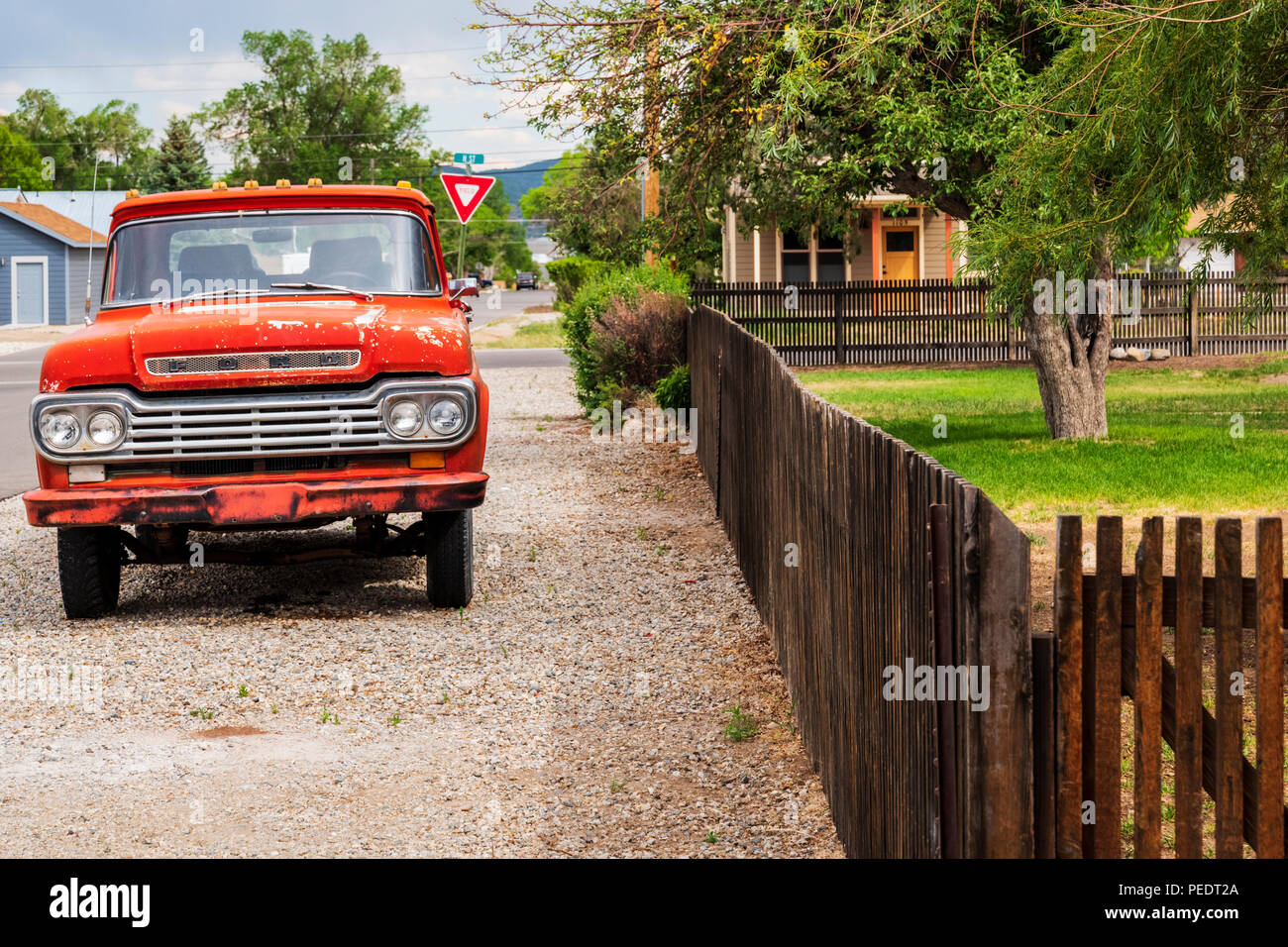 Antique Ford pick-up truck; wooden slat picket fence; Salida; Colorado; USA Stock Photo