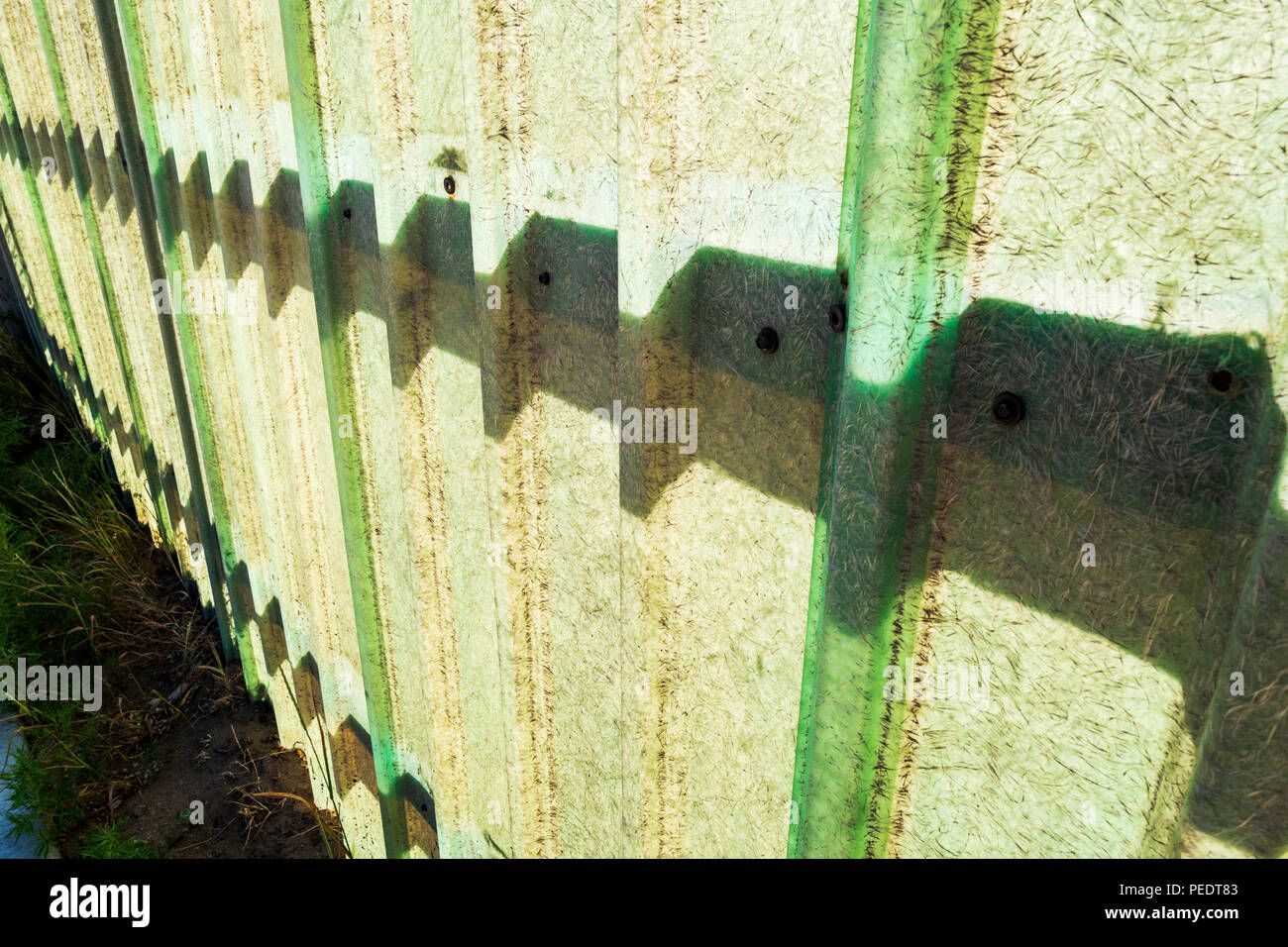 Graphic silhouetted patterns on transparent fiberglasss fence;   Salida; Colorado; USA Stock Photo