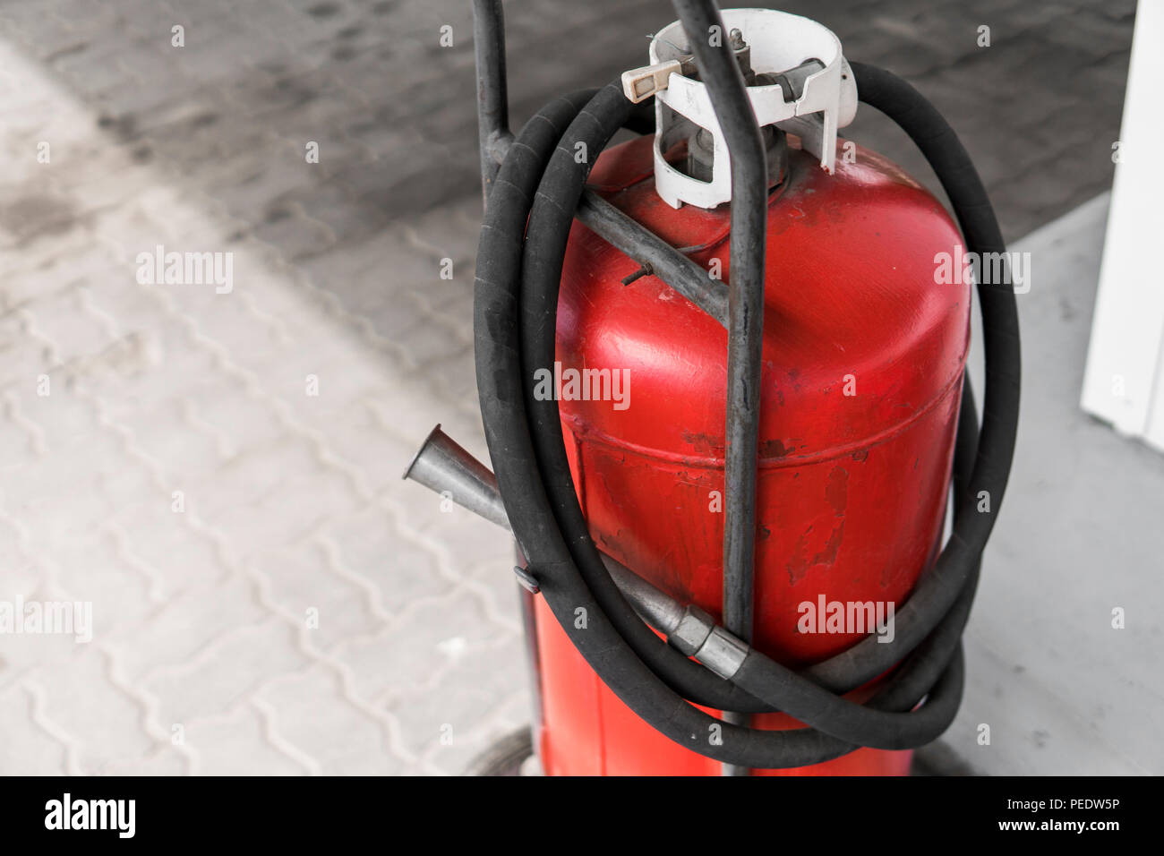 Red gas bottle cylinder with black tube Stock Photo Alamy