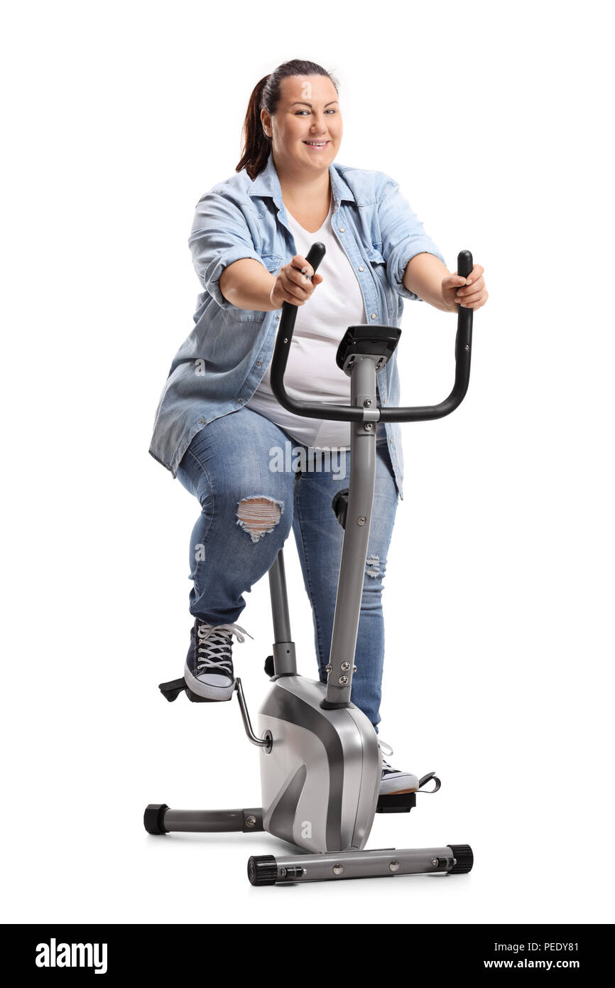 Overweight woman exercising on a stationary bike isolated on white background Stock Photo