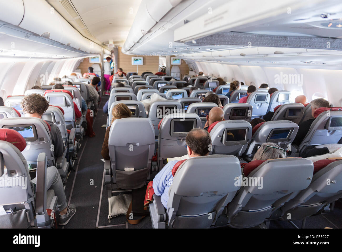 Interior of large commercial airplane with passengers on their seats during  flight Stock Photo - Alamy