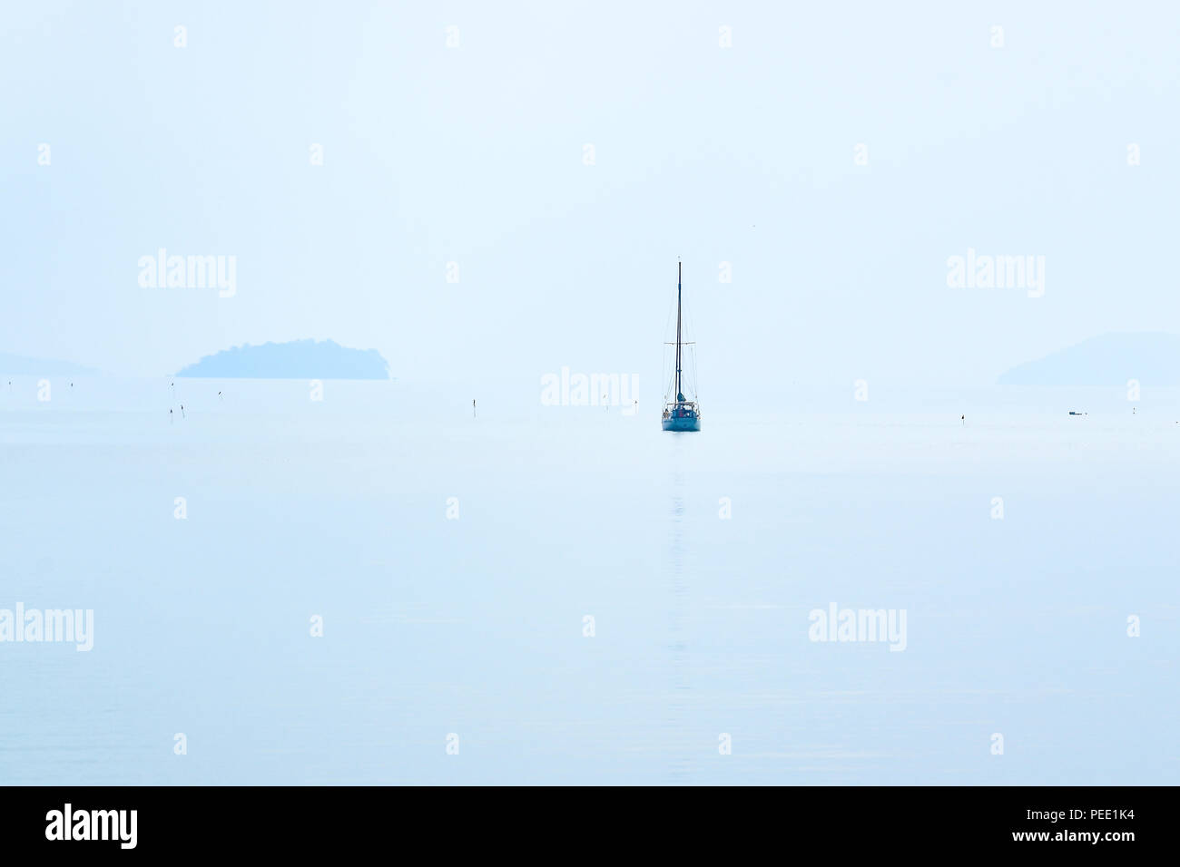 Lone sailing boat at the ocean Stock Photo - Alamy