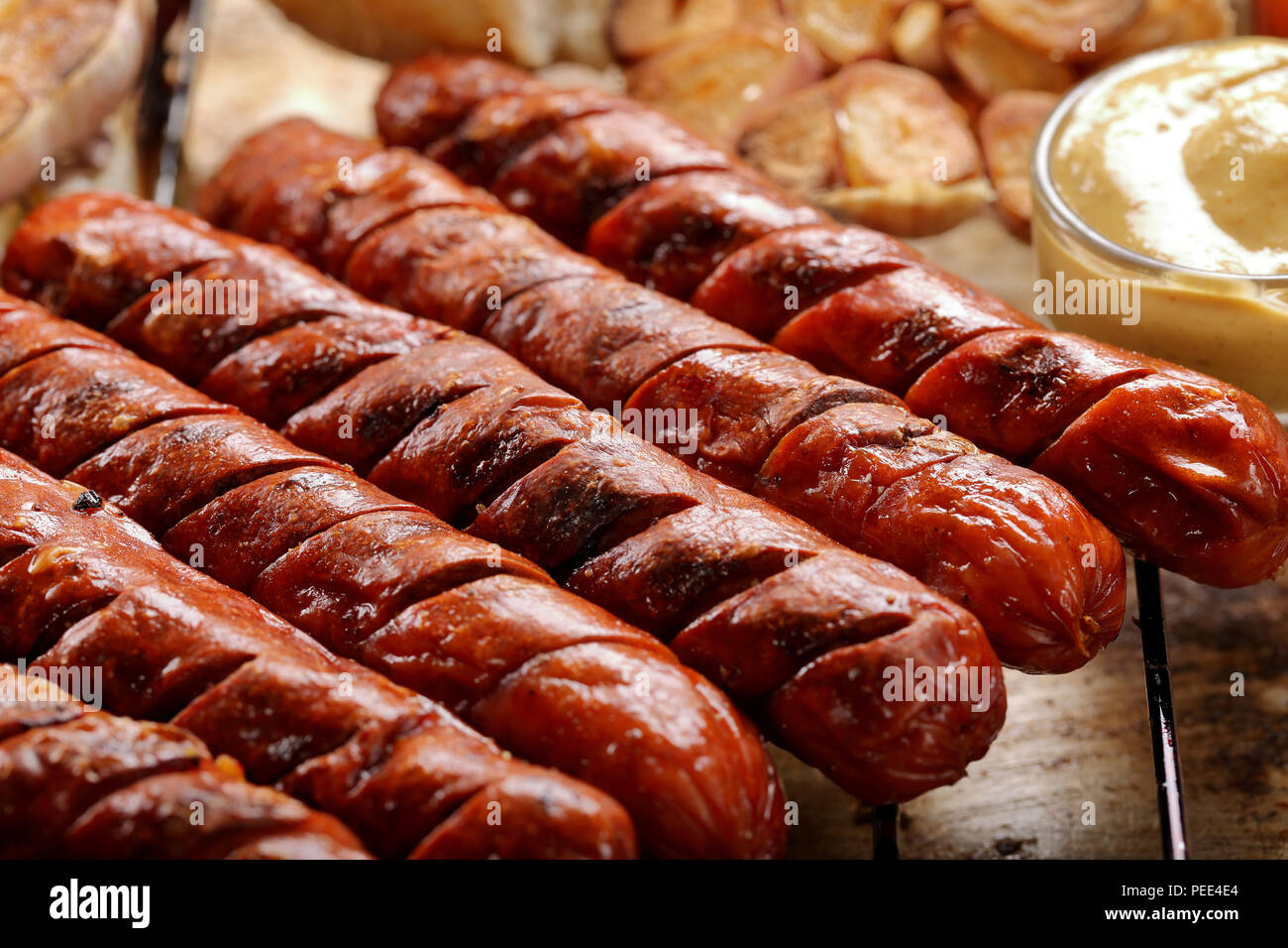 Grilled sausages in oven pan with garlic and onion Stock Photo Alamy