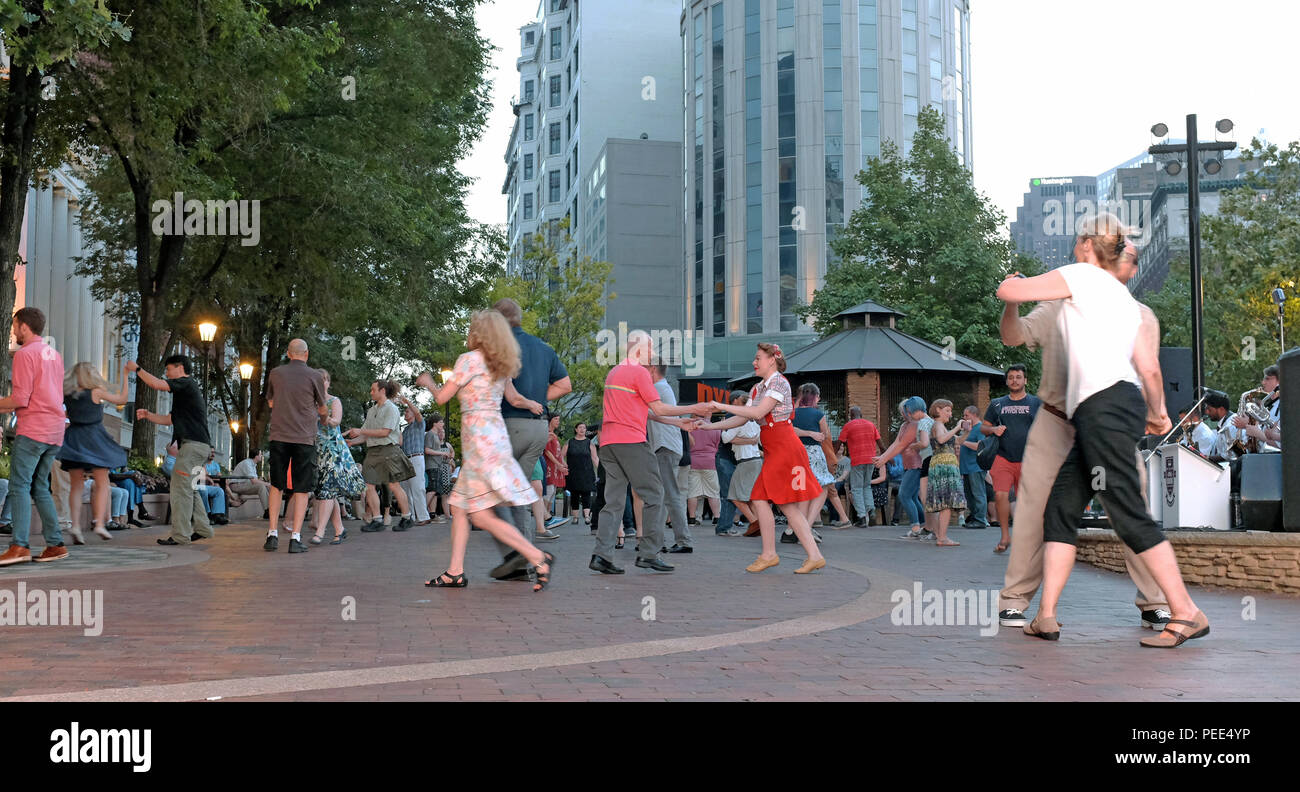 Cleveland residents swing dance to a live band as part of the summer 'Dancing Under the Stars' in Playhouse Square in downtown Cleveland, Ohio. Stock Photo