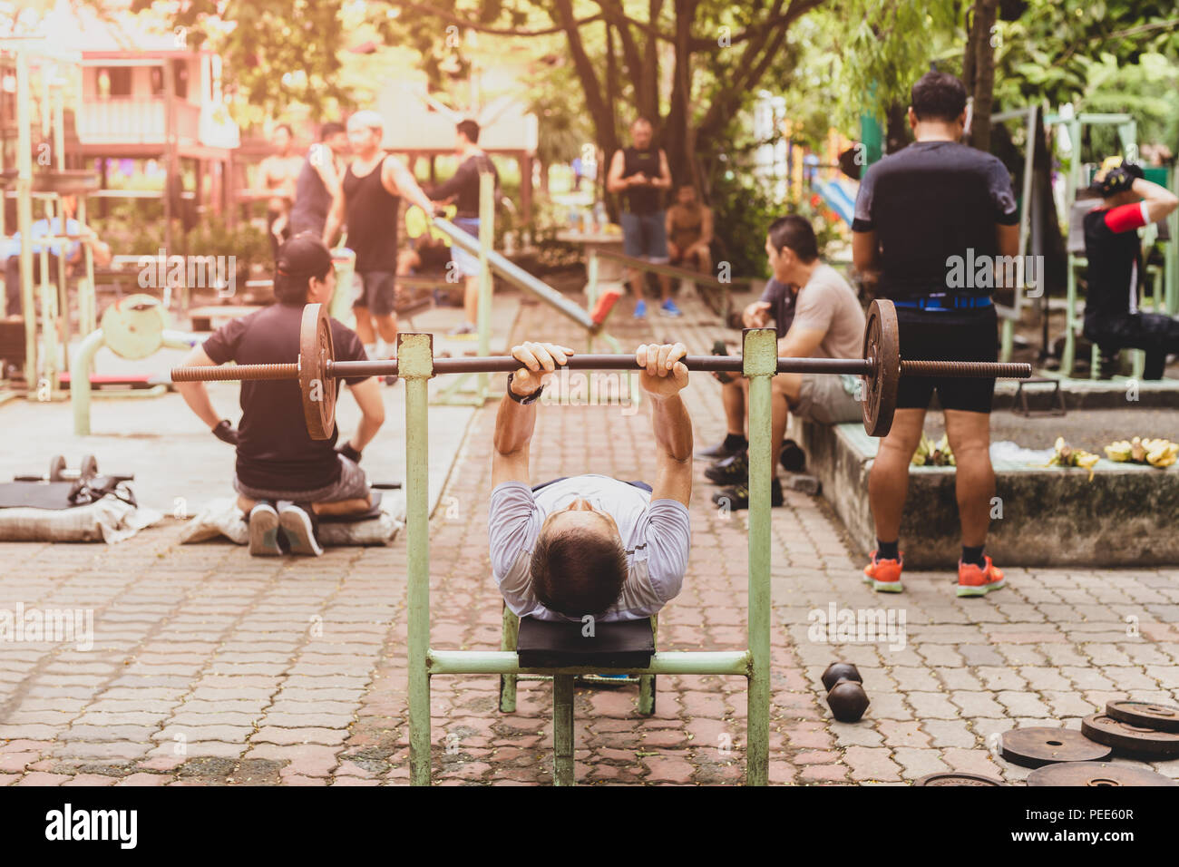 Selectd Focus Senior Man Working On Bench Press With Group Of