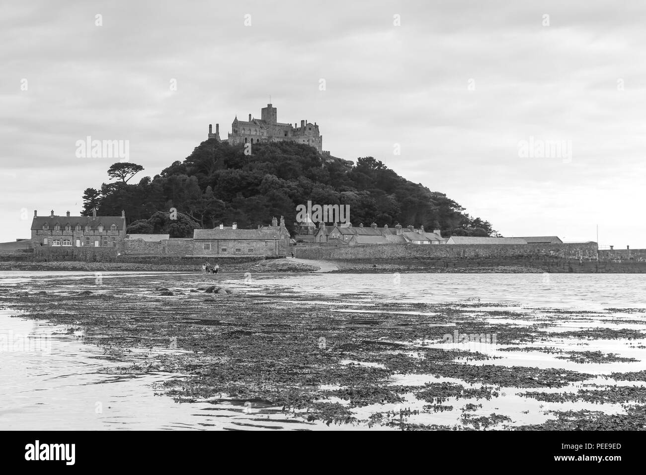 St. Michael's Mount castle is located on the top of an granitic-rock island near Marazion, Cornwall, England. At low tide you can walk to the island. Stock Photo