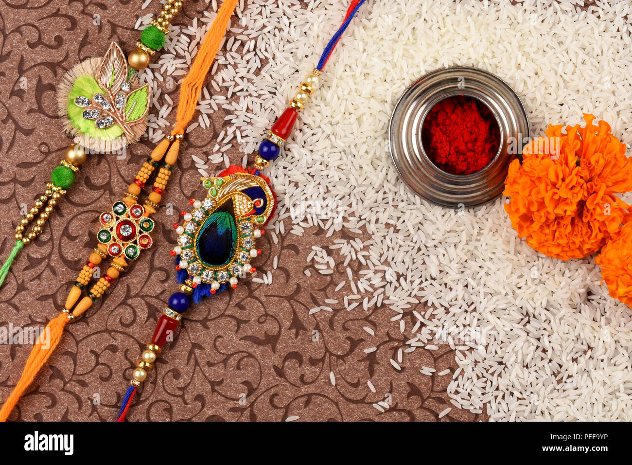 Indian Festival Raksha bandhan, rakhi with kumkum,rice and flowers Stock Photo