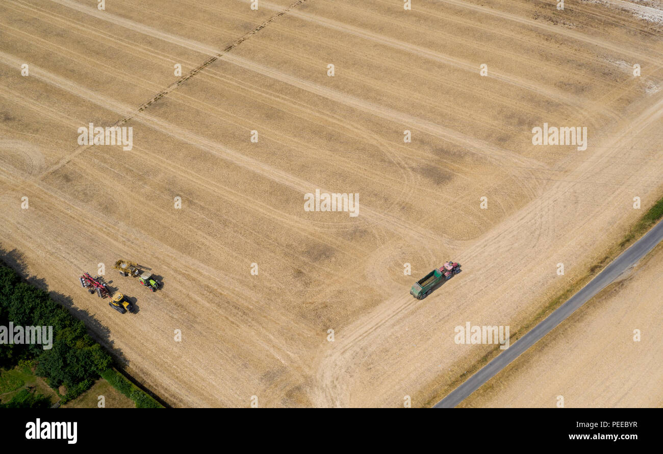 Aerial photos of tractors muck spreading during the summer harvest in Kent, UK Stock Photo