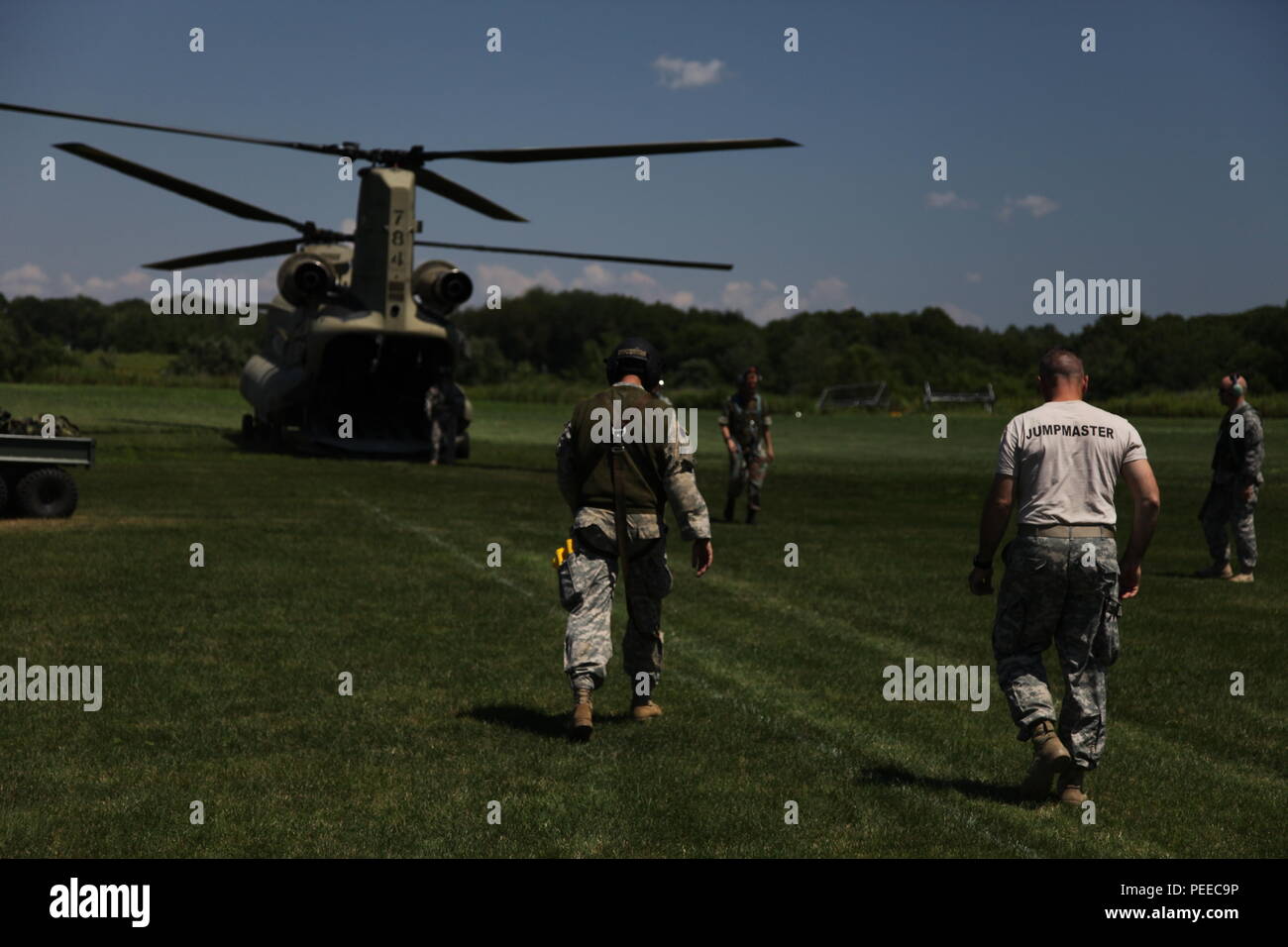 A U.S. Army jumpmaster, along with the flight crew, prepares to board a CH-47 Chinook helicopter prior to a  wing exchange jump at Leapfest in West Kingston, R.I., Aug. 3, 2015. Leapfest is an International parachute competition hosted by the 56th Troop Command, Rhode Island National Guard to promote high level technical training and esprit de corps within the International Airborne community. (U.S. Army Photo by Spc. Josephine Carlson/Released) Stock Photo