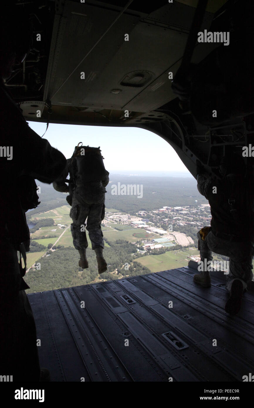 A U.S Army paratrooper jumps from a CH-47 Chinook helicopter during a wing exchange jump at Leapfest in West Kingston, R.I., Aug. 3, 2015. Leapfest is an International parachute competition hosted by the 56th Troop Command, Rhode Island National Guard to promote high level technical training and esprit de corps within the International Airborne community. (U.S. Army Photo by Spc. Josephine Carlson/Released) Stock Photo