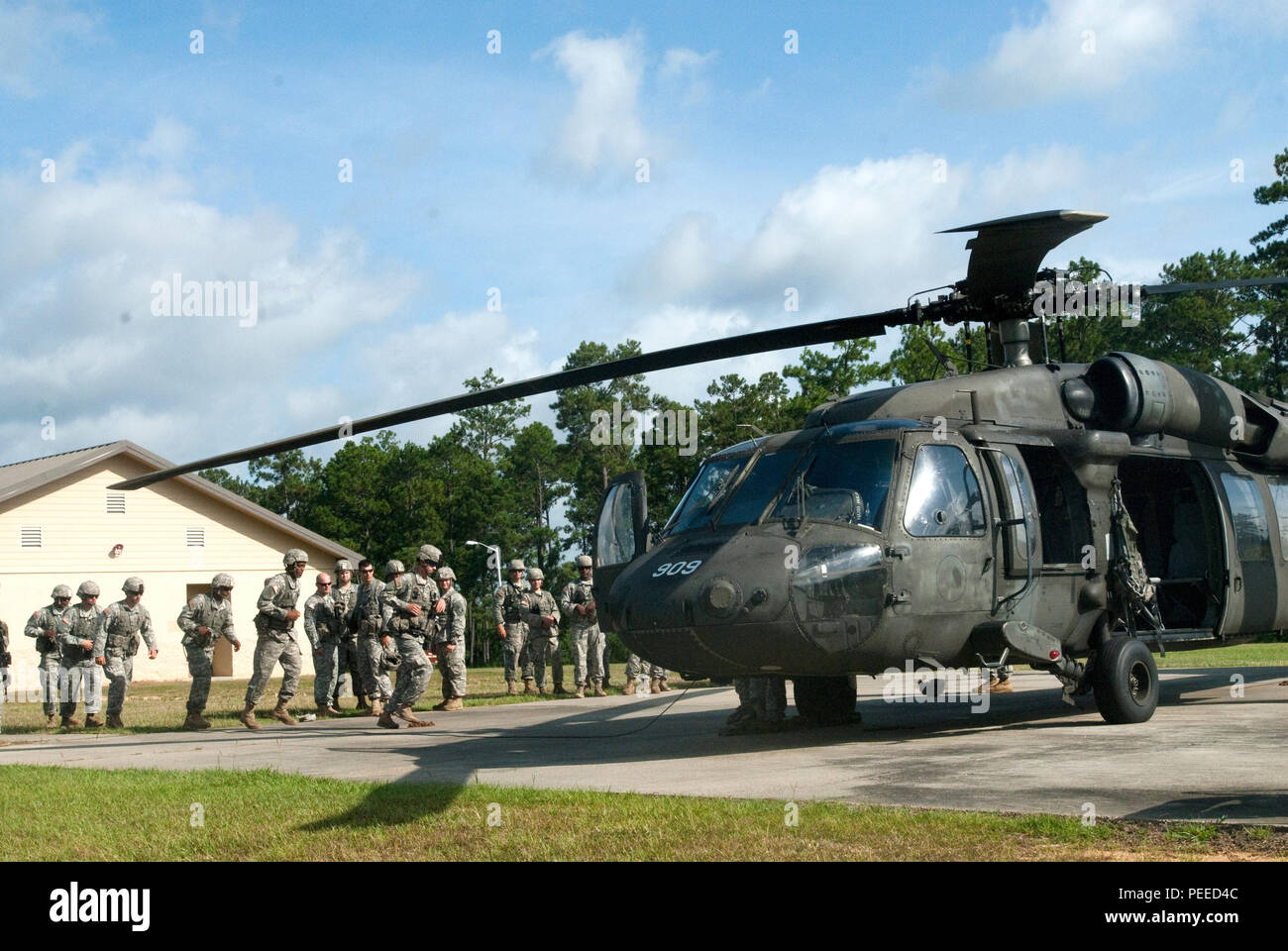 Soldiers of Troop B, 1st Squadron, 98th Cavalry Regiment, Mississippi Army National Guard, strengthen their individual and combat readiness training on a Black Hawk during an Exportable Combat Training Capability exercise at Camp Shelby Joint Forces Training Center, near Hattiesburg, Miss., on Aug. 6, 2015. This training brings rapid deployment for dismounted scouts and assists with putting eyes on the objective for mounted troops. (Mississippi National Guard photo by Sgt. DeUndra Brown, 102nd Public Affairs Detachment/Released) Stock Photo