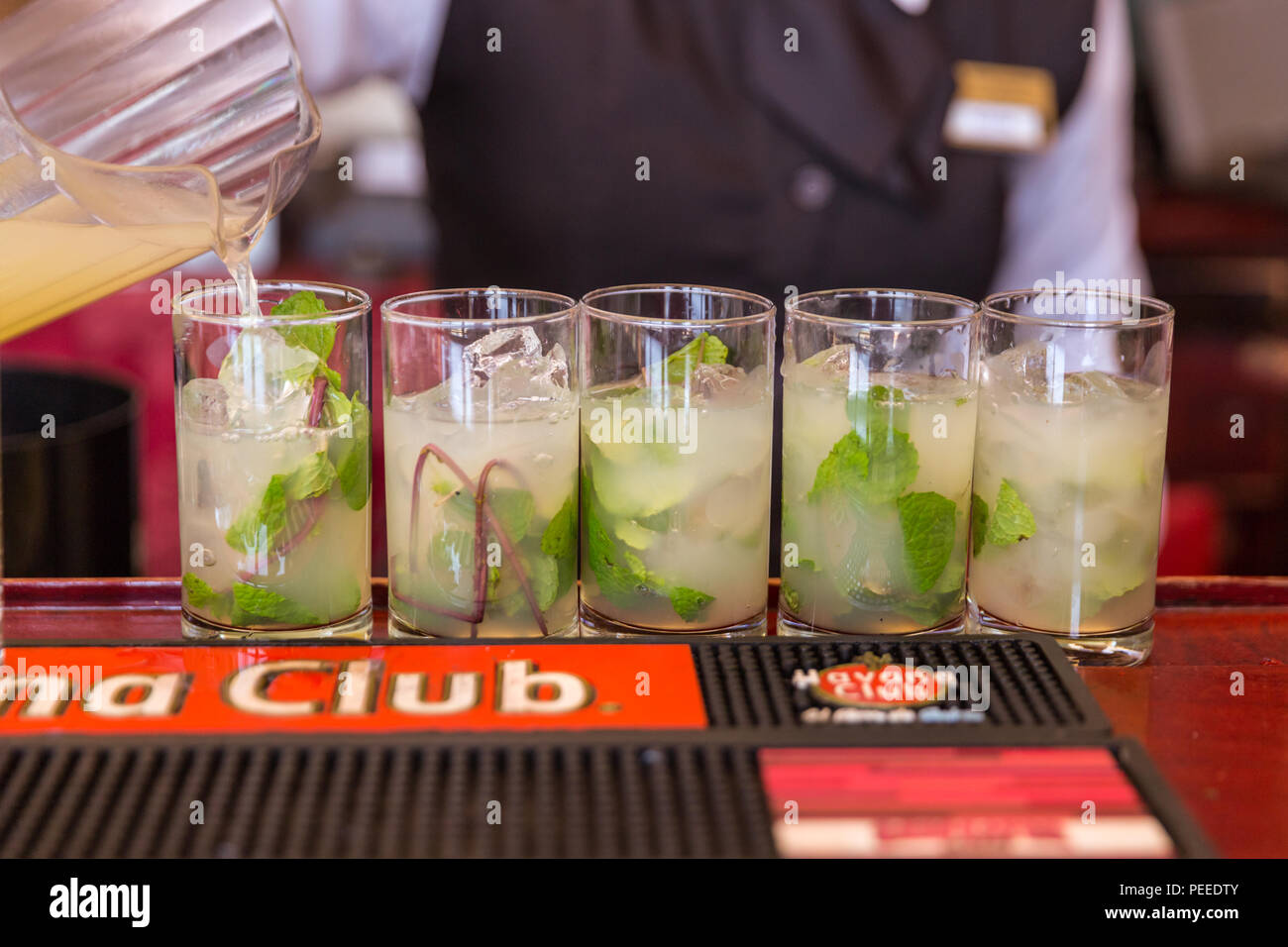 Mojitos being poured into glasses with rum in Havana, Cuba Stock Photo