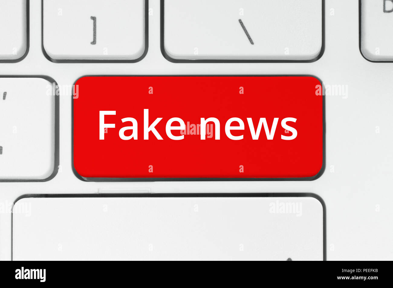 stop fakes - two red buttons on laptop keyboard. finger tries to press stop fake  buttons on a gray laptop. false news, facts and feelings in the moder Stock  Photo - Alamy