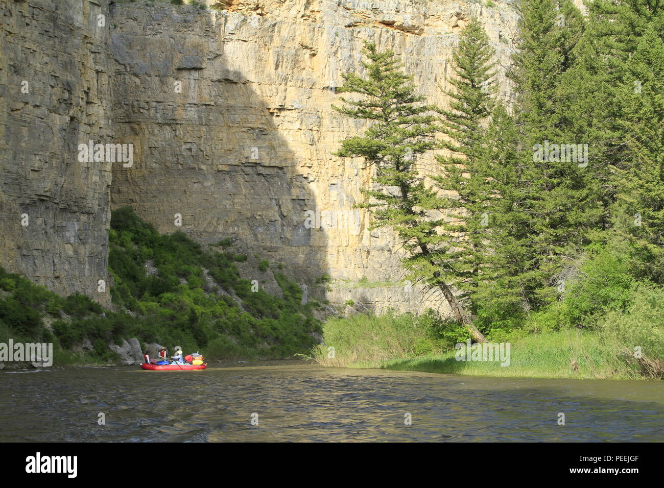 Rafters rounding a cliff bend in the river, Smith River State Park, Montana, USA Stock Photo