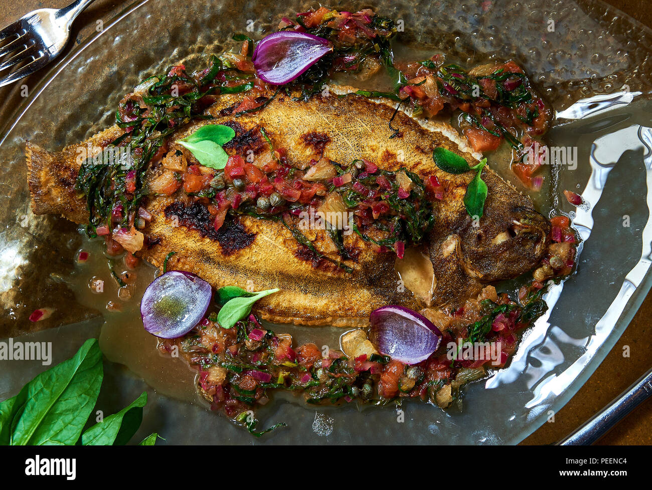 Baked whole flounder fish served with sauce Stock Photo Alamy
