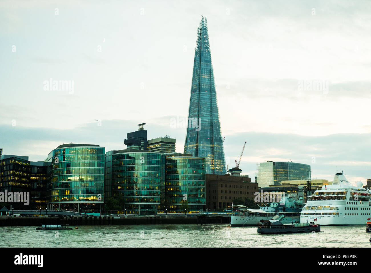 Cruise Ship on the River Thames with The Shard (of Glass) skyscraper & HMS Belfast museum ship, London. Stock Photo