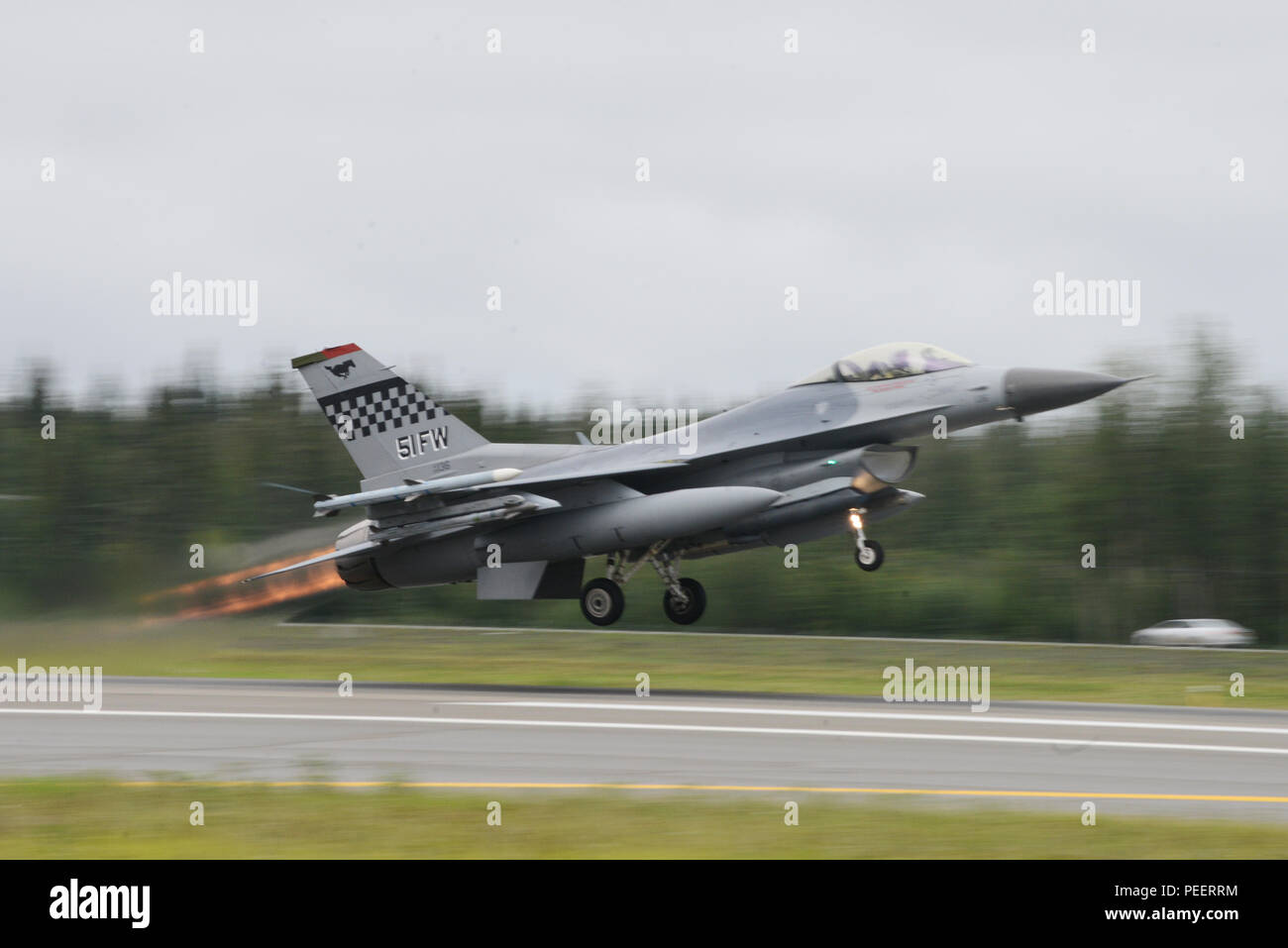 A U.S. Air Force F-16 Fighting Falcon assigned to the 36th Fighter Squadron, Osan Air Base, Republic of Korea, takes off from Eielson Air Force Base, Alaska, Aug. 10, 2015, during Red Flag-Alaska (RF-A) 15-3. RF-A is a series of Pacific Air Forces commander-directed field training exercises for U.S. and partner nation forces, providing combined offensive counter-air, interdiction, close air support and large force employment training in a simulated combat environment. (U.S. Air Force photo by Senior Airman Ashley Nicole Taylor/Released) Stock Photo