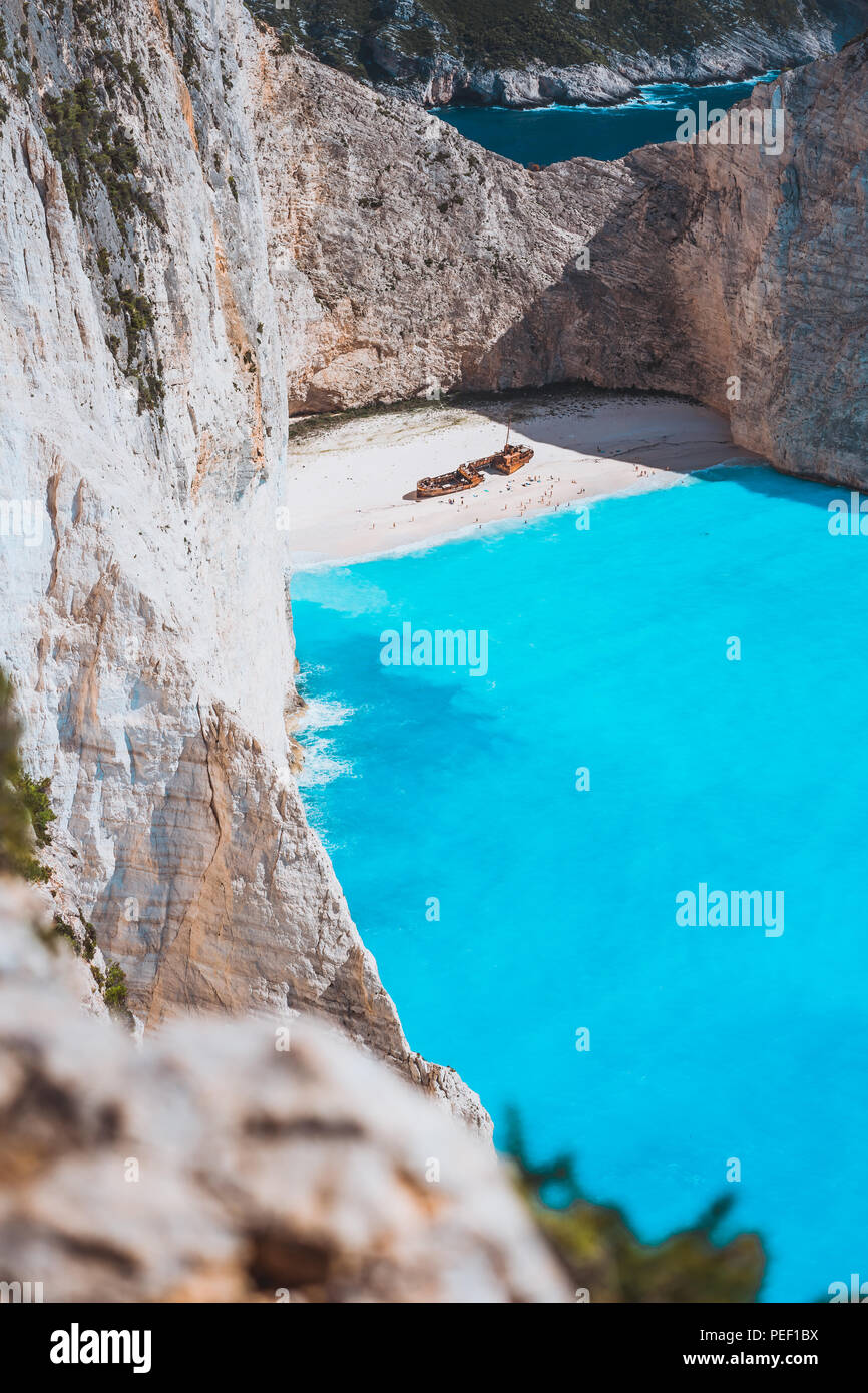 Limestone chalk colored like huge cliff rocks surrounding Navagio beach with Shipwreck and azure blue sea water. Zakynthos island, Greece Stock Photo