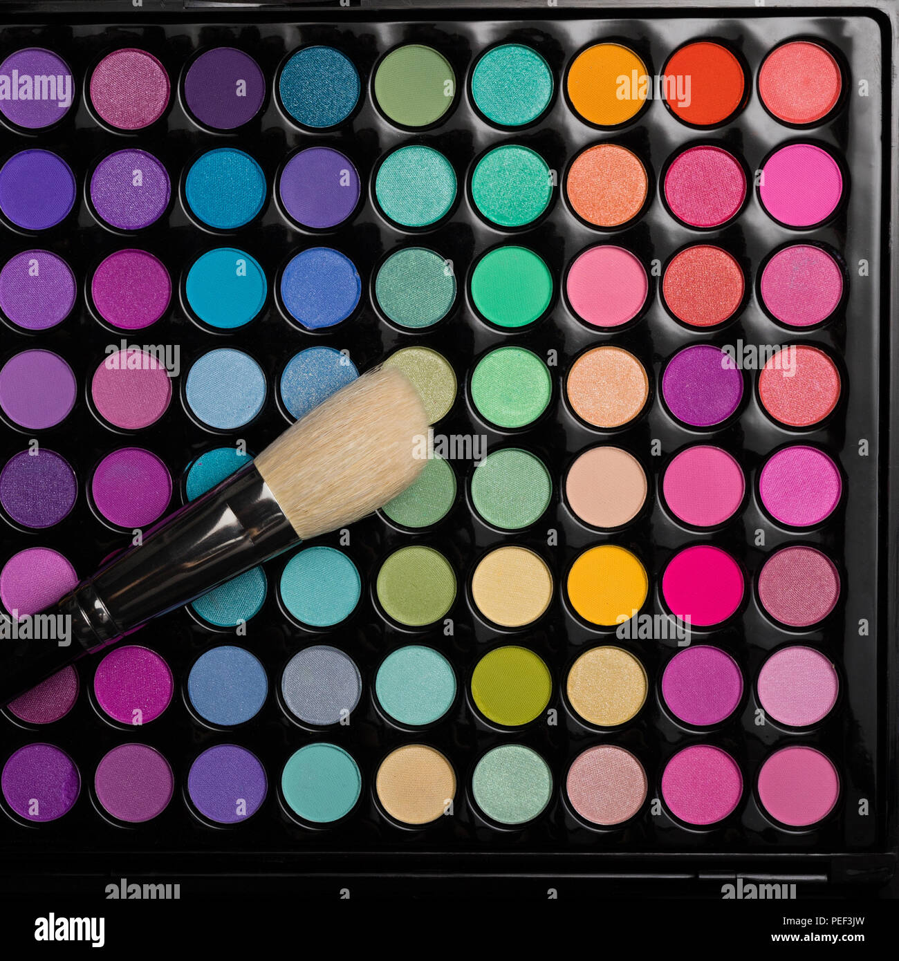 Make-up brush on colorful eyeshadow palette Stock Photo