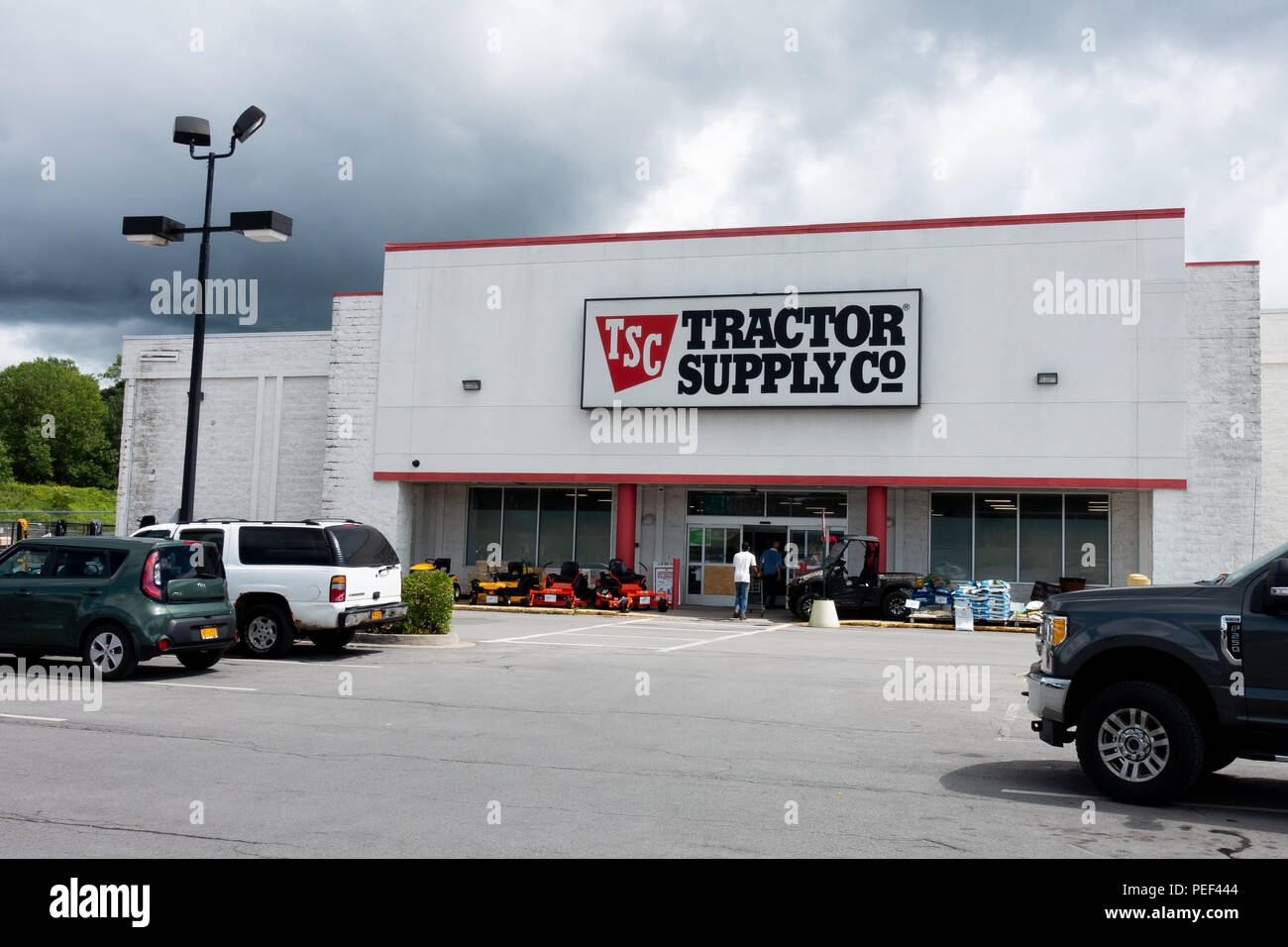 A Tractor Supply Co store in Utica, NY USA with vehicles and customers in the parking lot and merchandise on display on the sidewalk. Stock Photo