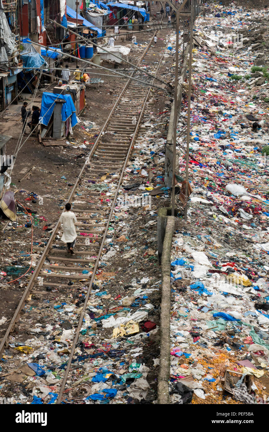Piles of plastic trash next to train tracks and slum area at Bandra train station, Mumbai, India Stock Photo