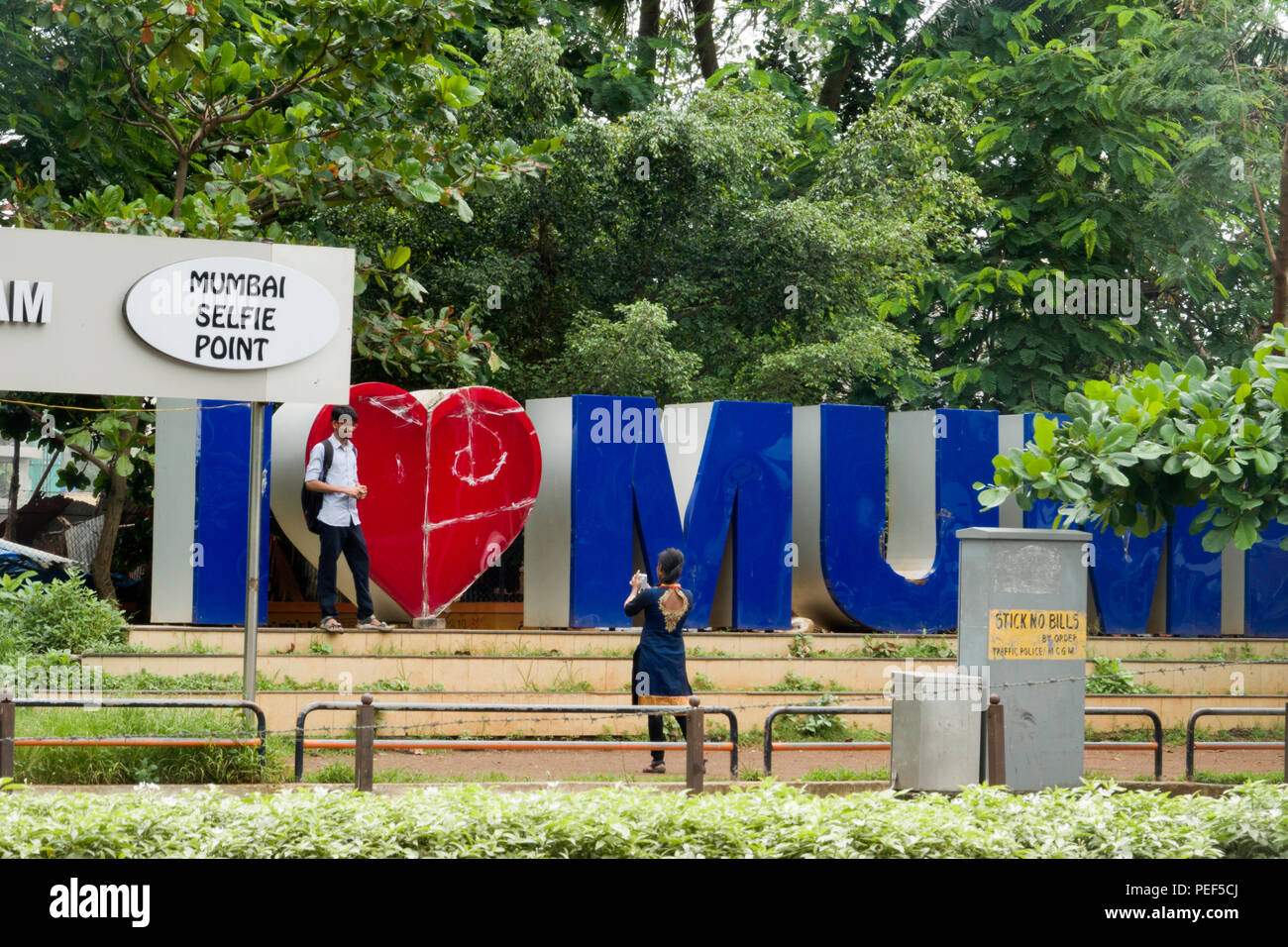 Indian couple taking photos at Mumbai Selfie Point in Juhu, Mumbai, India Stock Photo