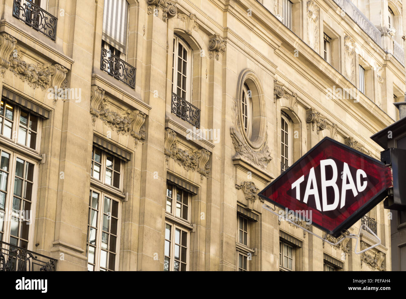 A diamond-shaped Tabac sign indicating a shop selling cigarettes in France. Stock Photo
