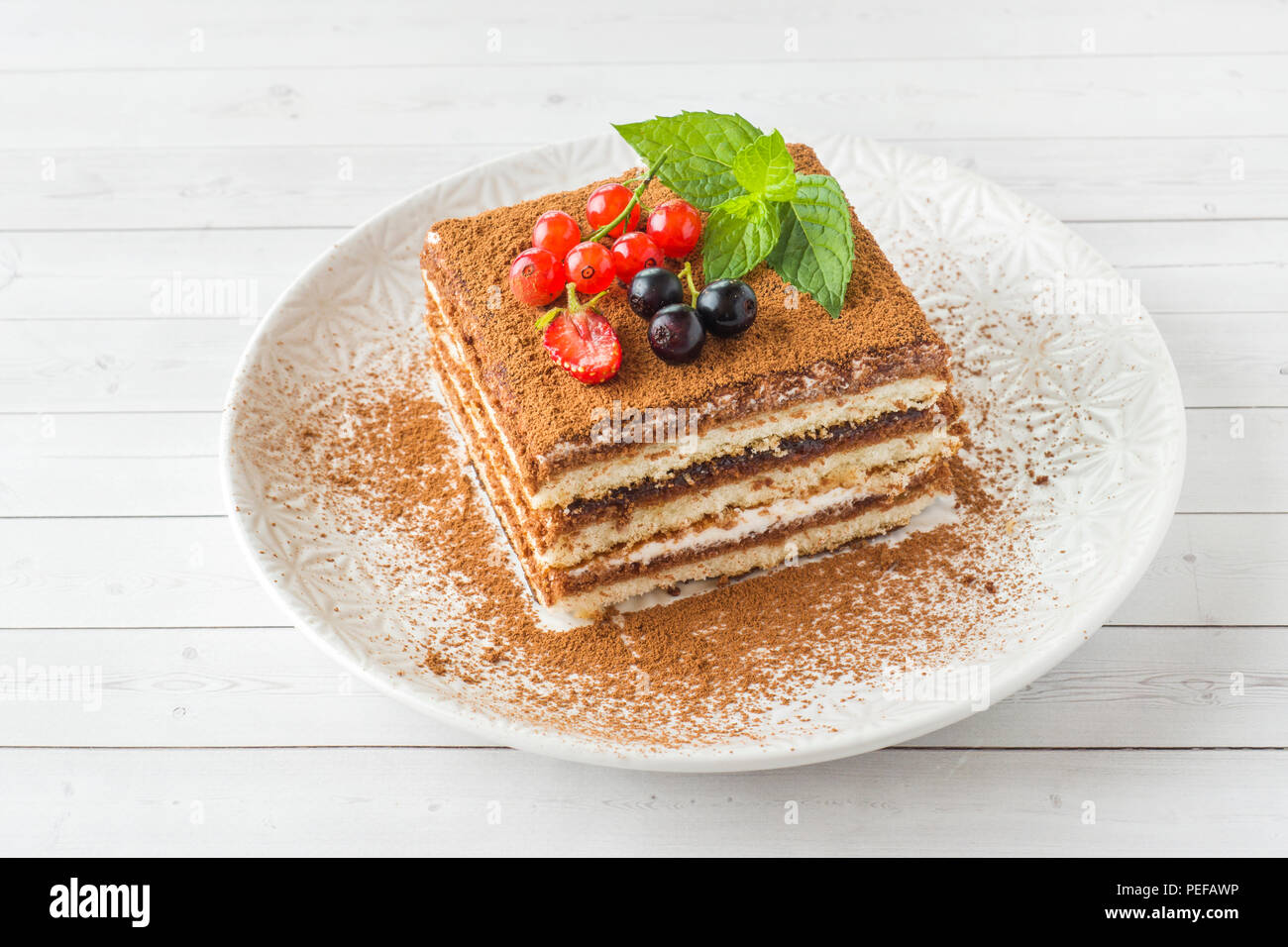 Delicious Tiramisu Cake With Fresh Berries And Mint On A Plate On A Light Background Stock Photo Alamy Delicious Tiramisu Cake With Fresh Berries And Mint On A Plate On A Light Background Stock Photo Alamy