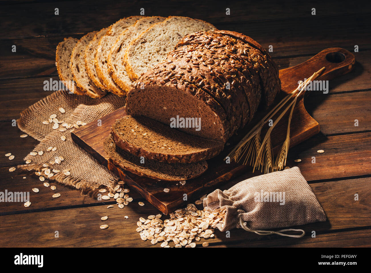 Rustic Bread Table Rustic wooden table with rye bread and oats on top, rustic style Stock ...