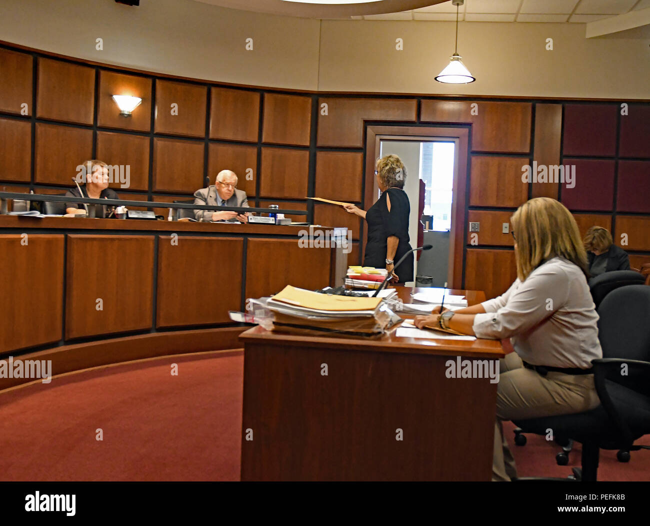 Emporia Kansas, USA, August 13, 2018 Members of the Lyon County Kansas, Board of Canvassers look over ballets presented to them by Lyon County Clerk Tammy Vopat and Lyon County Deputy Election Officer Amie Jackson as part of the statewide recount of the Republican gubernatorial primary election to determine the winner between incumbent Governor Jeff Colyer and his challenger Secretary of State Kris Kobach. Tammy Vopat hands ballots to Lyon County Counselor Marc Goodman Stock Photo