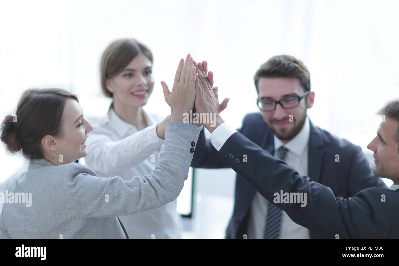 successful business team giving each other a high-five, standing in the ...