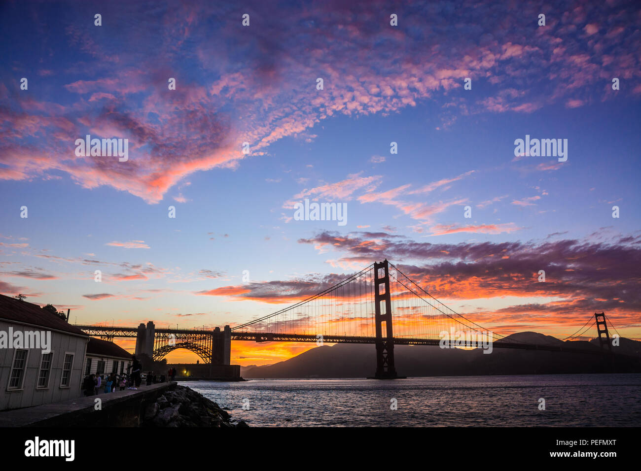 A beautiful sunset over San Francisco's famous Golden Gate Bridge and San Francisco Bay as seen from Crissy Field near Fort Point. Stock Photo